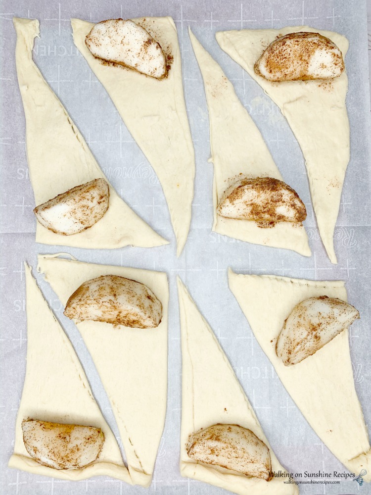 Place apple wedges on top of triangle crescent rolls.