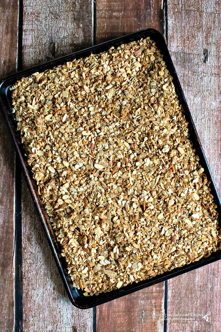Recipe for Homemade Granola is filled with almonds, brown sugar and peanut butter! There's no going back to the store version once you've tasted this from Walking on Sunshine Recipes. Baked Homemade Granola in Baking Tray