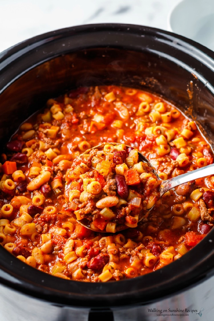 Pasta Fagioli Soup in Crock Pot cooked and ready to serve with soup ladle. 