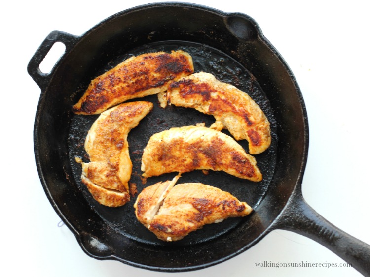 Cooked chicken in cast iron skillet from Walking on Sunshine Recipes