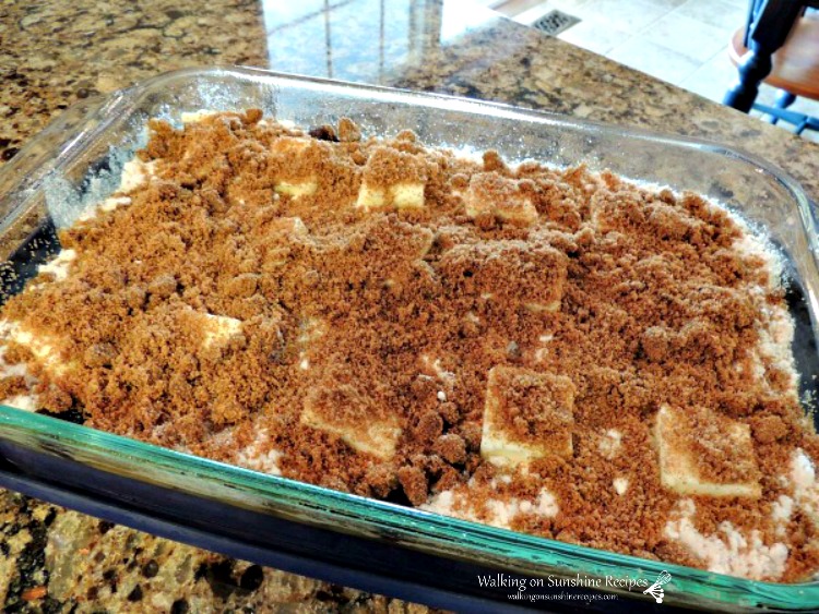 Peach Crunch Cake topped with brown sugar and butter.