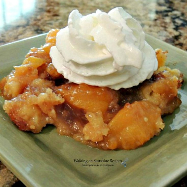 Peach Crunch Dump Cake on green plate with Whipped Cream