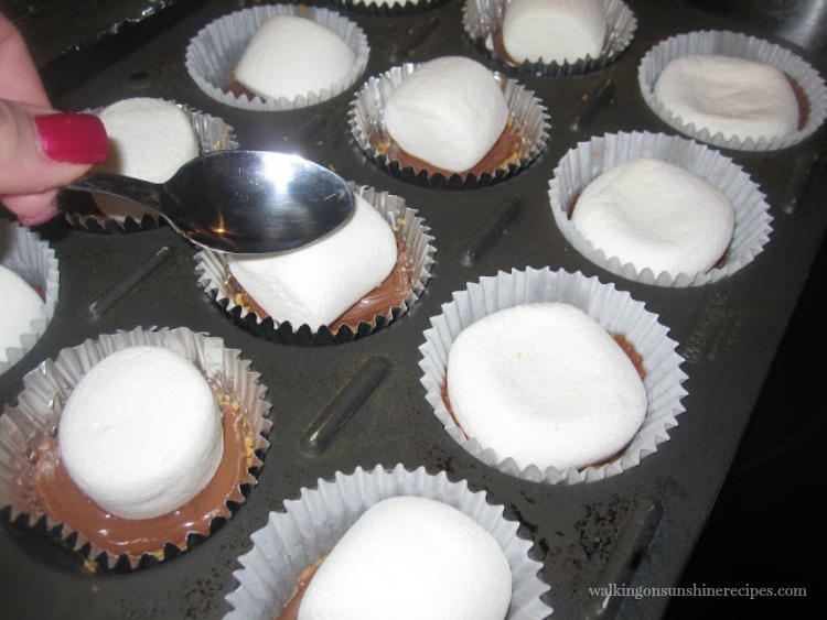 S'mores Cookie Cups: Easy, Delicious and Made in the Oven from Walking on Sunshine Recipes. Press the Marshmallow down with the back of a spoon for S'mores Cookie Cups from Walking on Sunshine Recipes.