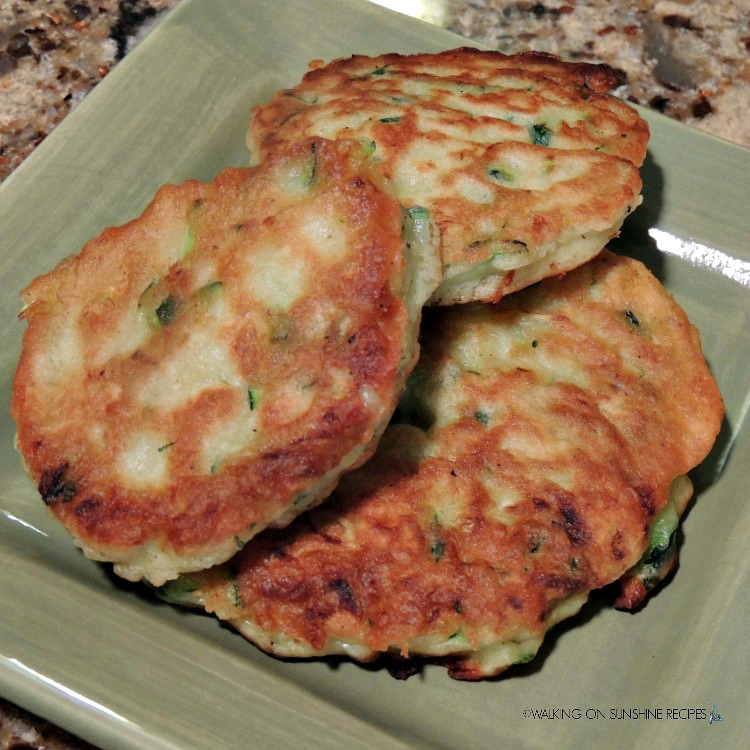 zucchini fritters on green plate. 