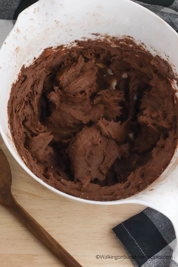 Homemade chocolate frosting in white bowl. 