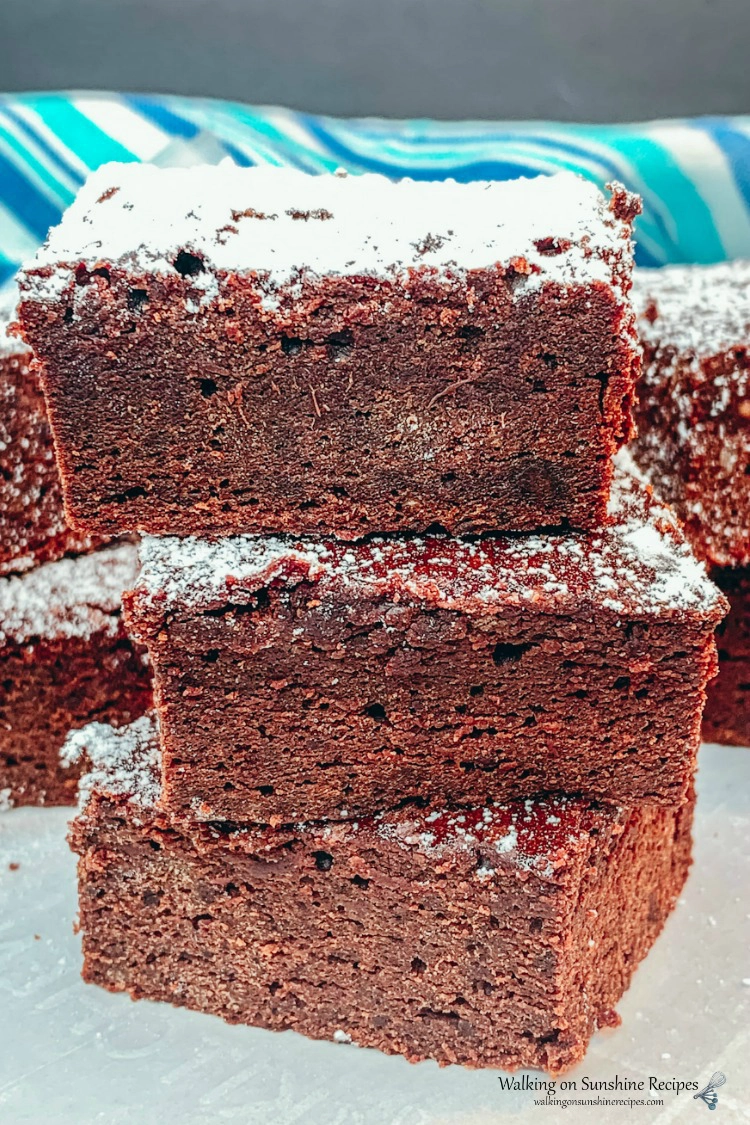 Brownies stacked with powdered sugar on top