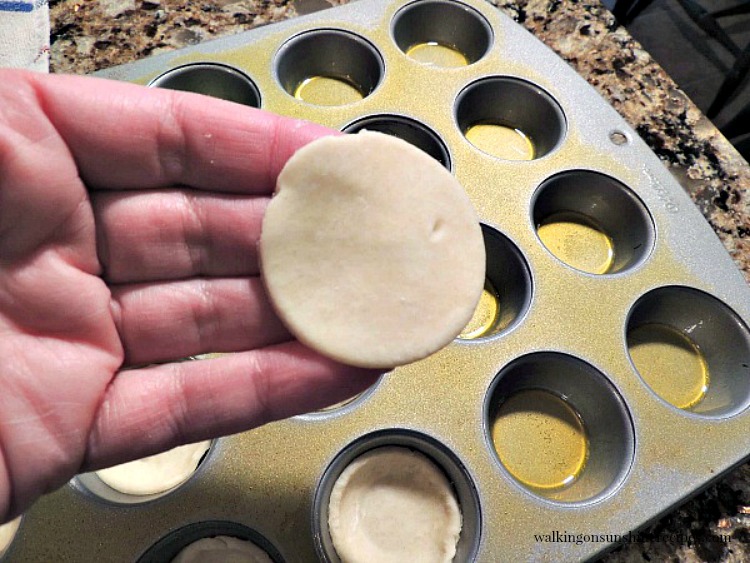 Add the pie crust cut outs to a mini muffin pan from Walking on Sunshine.