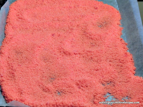Allow colored sugar to dry on a baking try lined with waxed paper. 