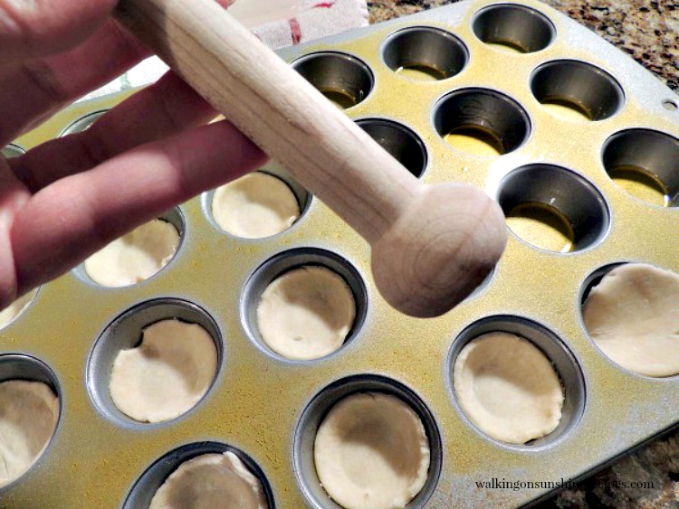 Mini Tart Shaper is the best tool to use for fitting pie crust circles in a muffin pan.