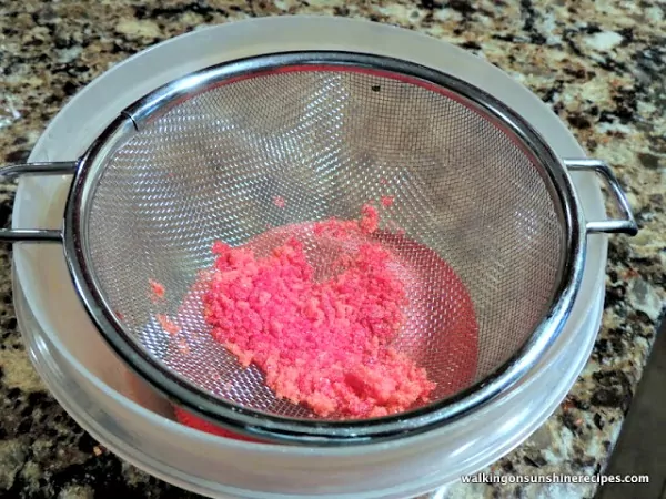 Press the colored sugar through a fine mesh sieve to remove all the lumps. 