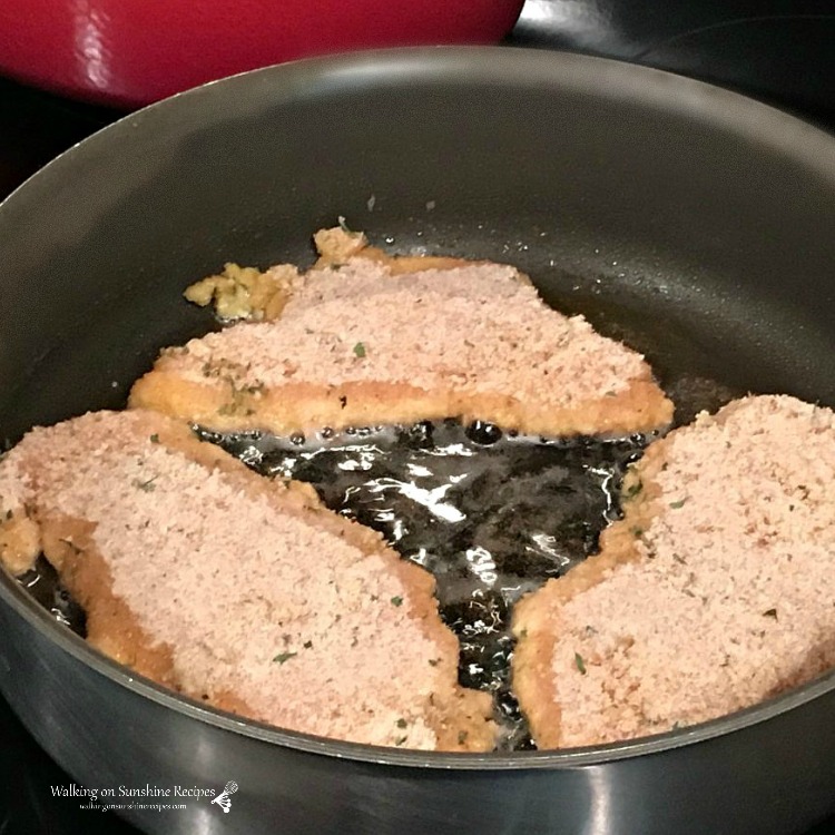 breaded chicken cutlet in frying pan