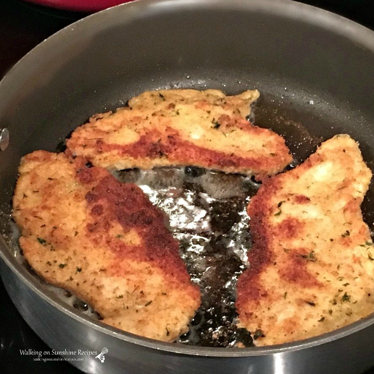 Chicken cutlet breaded in frying pan with oil 