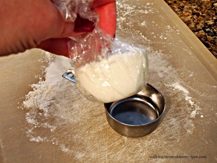 Pull shortening in plastic wrap out of measuring cup.