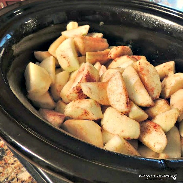 chopped apples in crock pot for homemade apple sauce.