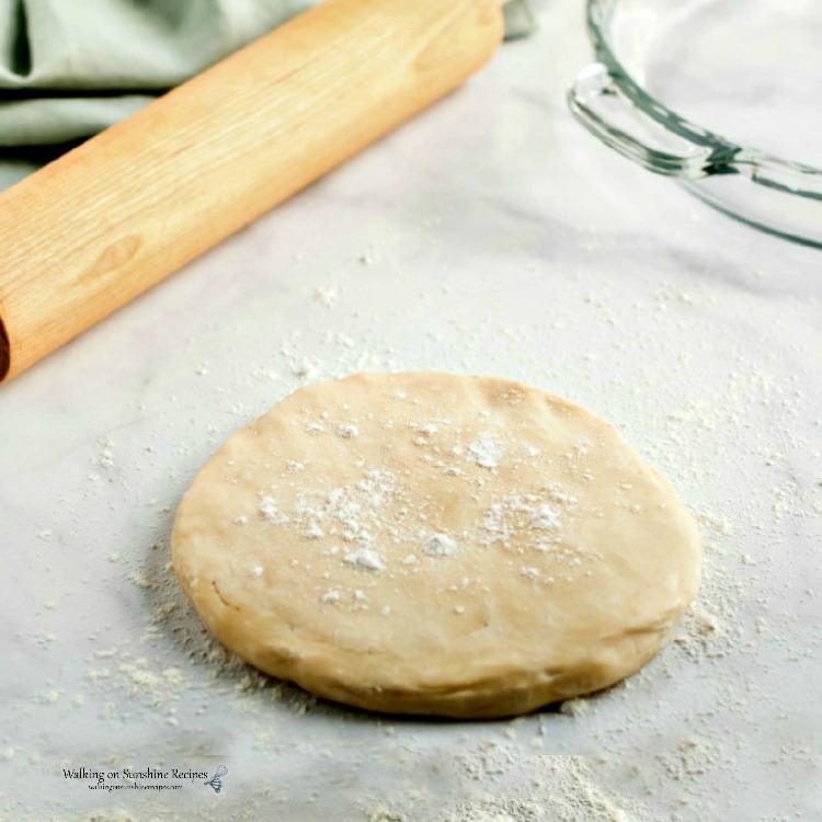 disc of pie dough on floured surface.