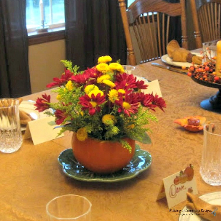 Real pumpkin as Thanksgiving centerpiece with fresh flowers. 