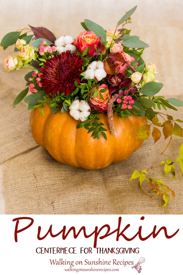 Thanksgiving centerpiece made out of a hollowed out pumpkin and fall flowers. 