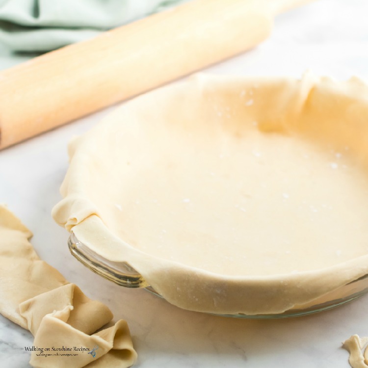 unbaked pie shell with rolling pin. 