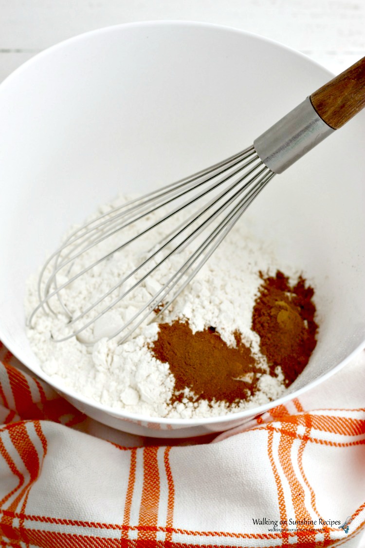 Ingredients for Pumpkin Pancakes in mixing bowl with wire whisk