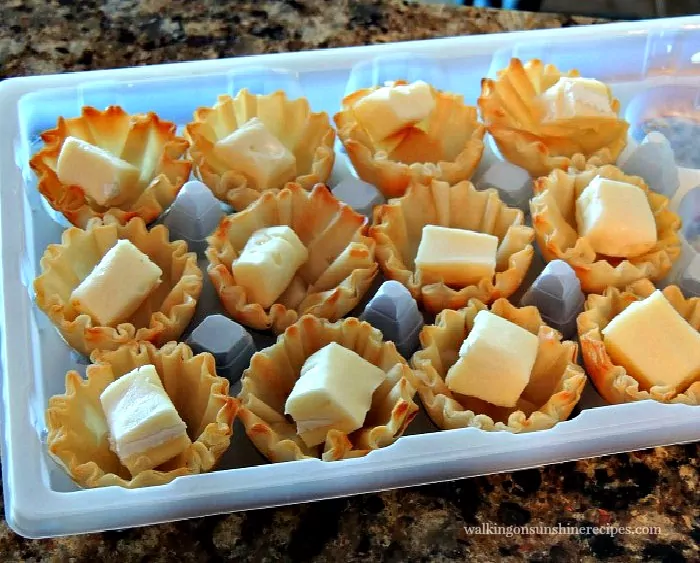 Place a small cube of brie cheese inside each phyllo cup. 