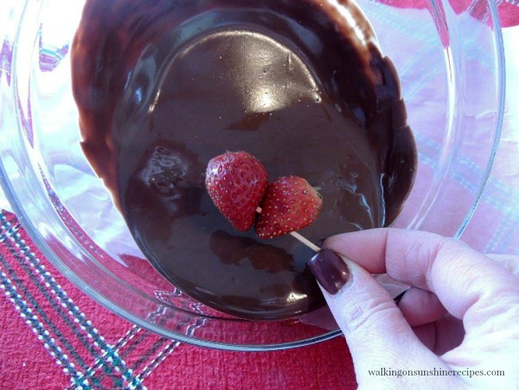 Dip the strawberry heart in melted chocolate. 
