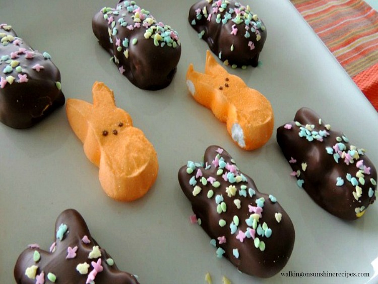 Chocolate Covered Peeps are a fun and easy treat to make this Spring and especially for Easter that kids of all ages are going to love from Walking on Sunshine Recipes. Chocolate Covered Marshmallow Peeps and Bunnies on white platter
