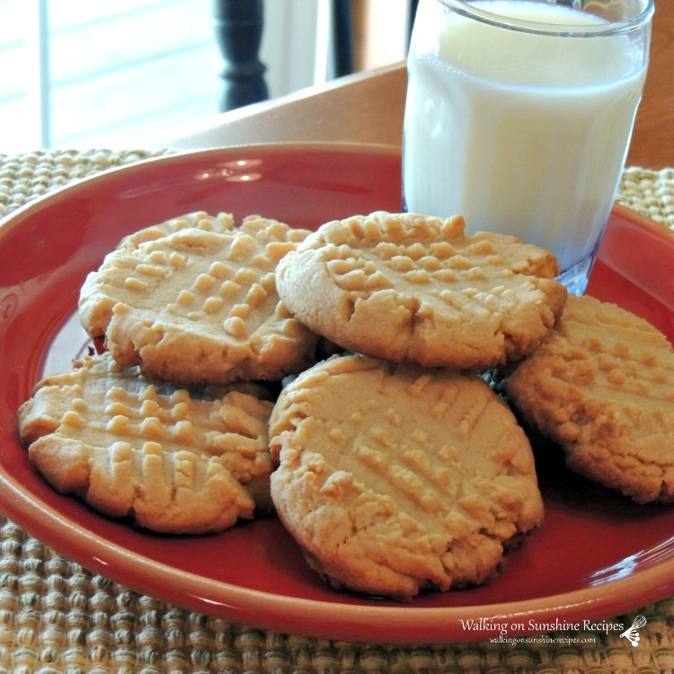 https://walkingonsunshinerecipes.com/wp-content/uploads/2014/05/Peanut-Butter-Cookies-with-glass-of-milk-on-red-plate.-Cookies-made-from-Cake-Mix-with-logo.jpg