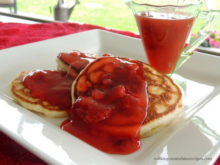 Homemade Strawberry Sauce over Pancakes on white plate from Walking on Sunshine Recipes 