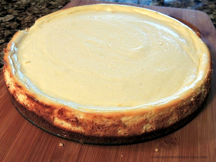 Cheesecake cooling on cutting board. 