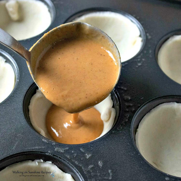 Spoon Pumpkin Pie Filling into muffin pans