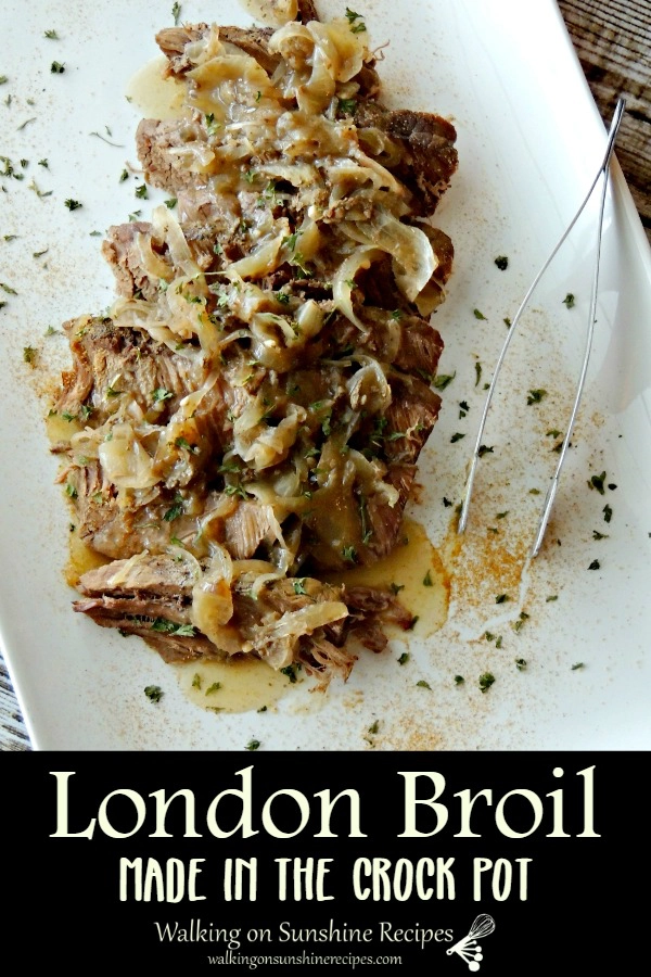 London broil crock pot on white platter with onions. 