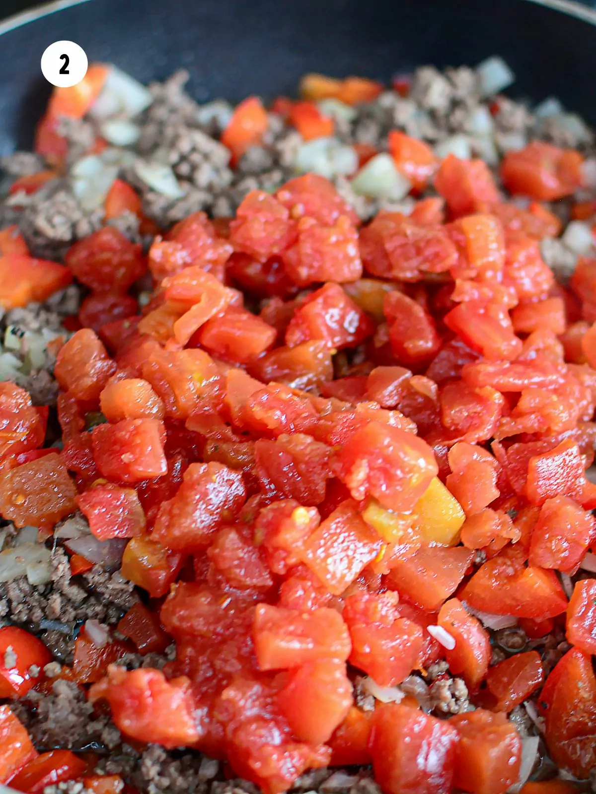 Stir in the tomatoes, onion, and peppers