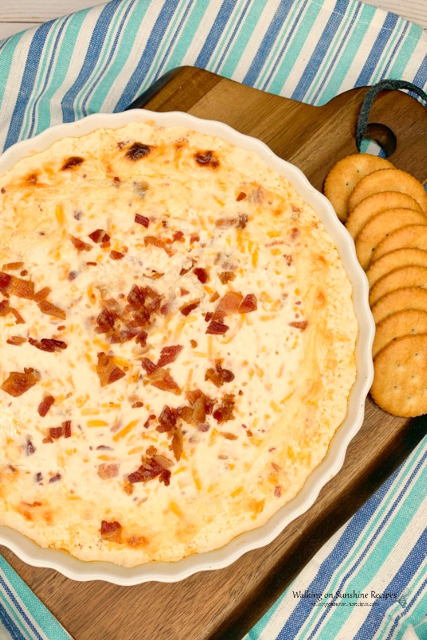 Bacon Cheese Dip baked in oven served with buttery crackers. 