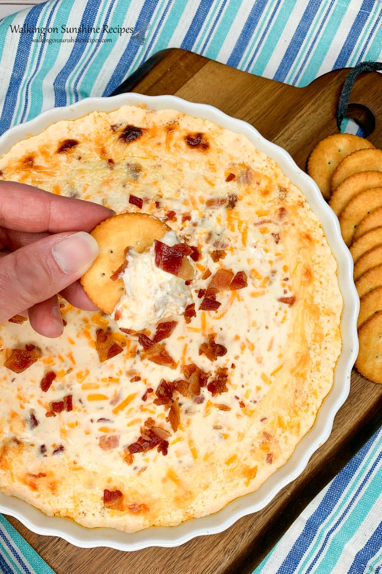 Buttery cracker dipped in Warm Bacon Cheese Dip