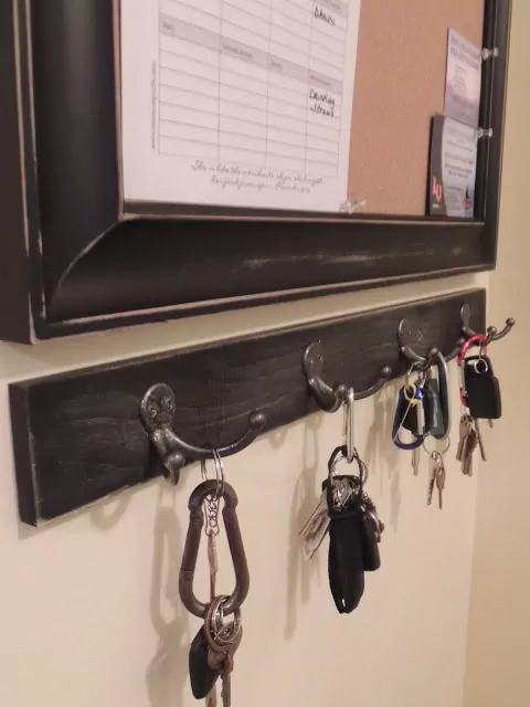 Close up of the DIY Industrial Style Message Center from Walking on Sunshine with the key holder.