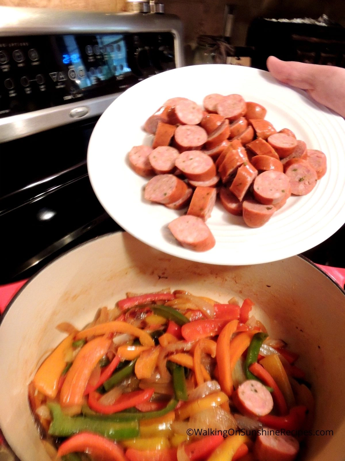 Add sausage to cooked peppers and onions.