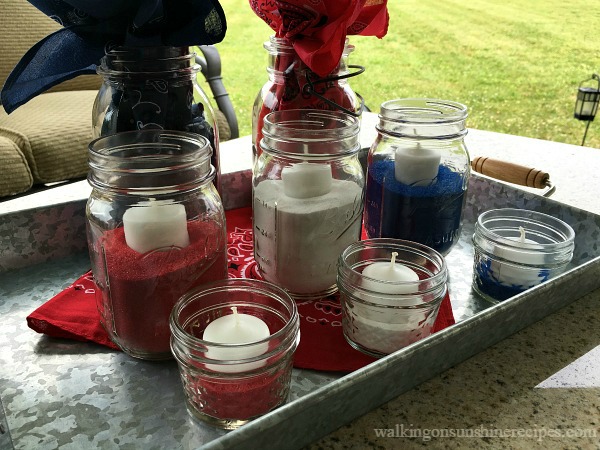 Mason Jar Patriotic Table Centerpiece with mason jars, colored sand and candles. 