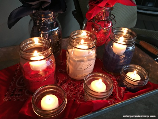 Mason Jar Patriotic Table Centerpiece with mason jars, colored sand and candles. 