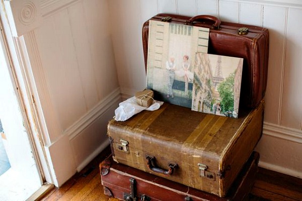 Photo boards on top of old suitcases