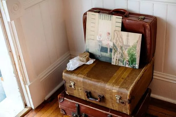 Photo boards on top of old suitcases