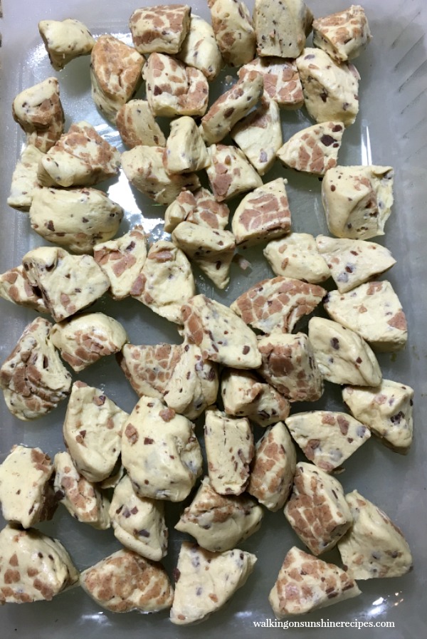 Cut up refrigerator cinnamon biscuits in the bottom of a glass baking dish. 