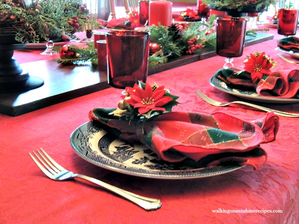 Dining room table set for Christmas with Blue Willow Plates and red stemware from Walking on Sunshine. 