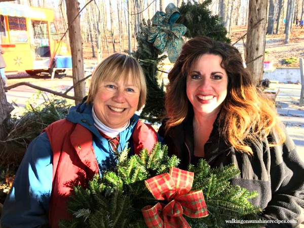 Christmas tree owner and me with a fresh made wreath from Walking on Sunshine.