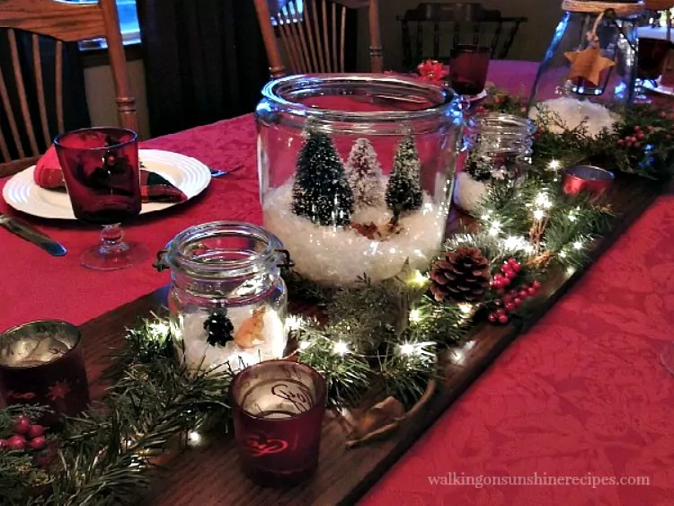 Christmas table set with terrariums and Christmas lights