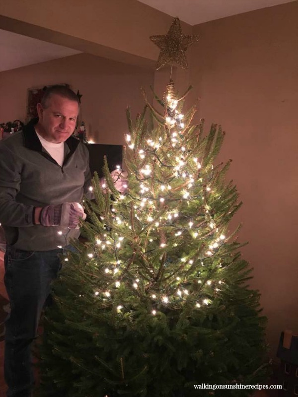 Phil putting lights on our tree from the Christmas tree farm 2016 from Walking on Sunshine Recipes