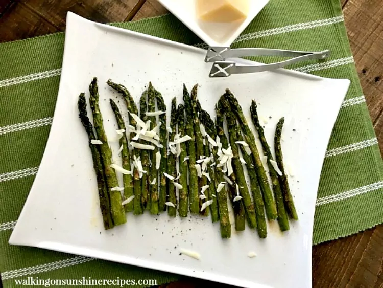 Roasted Asparagus on White Platter with Parmesan Cheese shavings. 