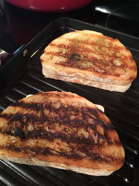 Grilled Pesto Panini Sandwiches cooking on grill pan from Walking on Sunshine.
