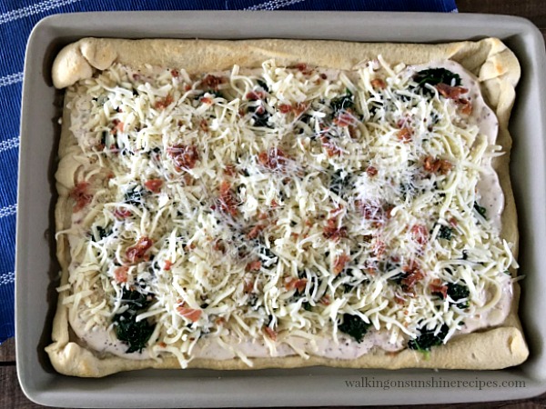 Add another layer of cheese and bacon to the Spinach Alfredo Bacon Pizza from Walking on Sunshine
