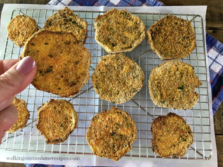 Closeup of crispy baked eggplant slices on wire baking rack. 