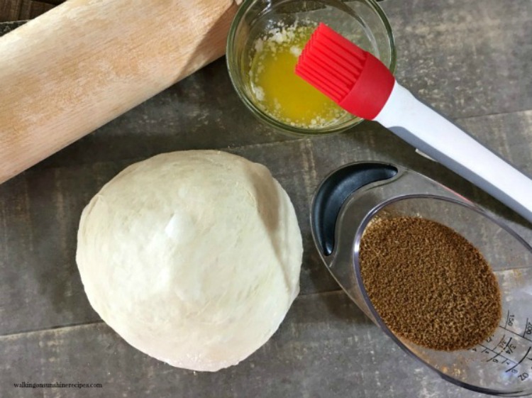Easy Cinnamon Rolls ingredients, loaf of bread dough, melted butter and cinnamon.